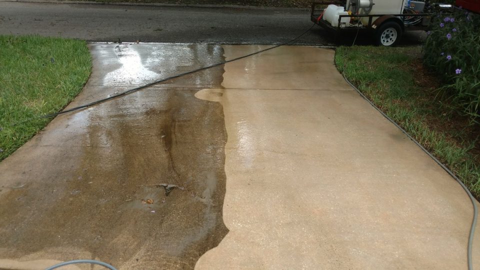 Pressure washing a driveway in progress
